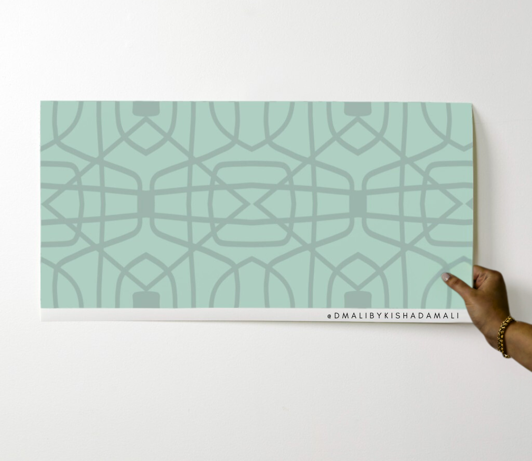 Mint green decorative panel with geometric pattern held by a hand on a white background, featuring the brand 'D'MALIBYKISHADAMALI'.